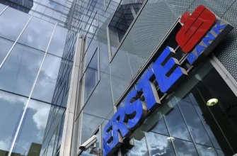 Стеклянный фасад офисного здания с синим логотипом и надписью Erste Bank.